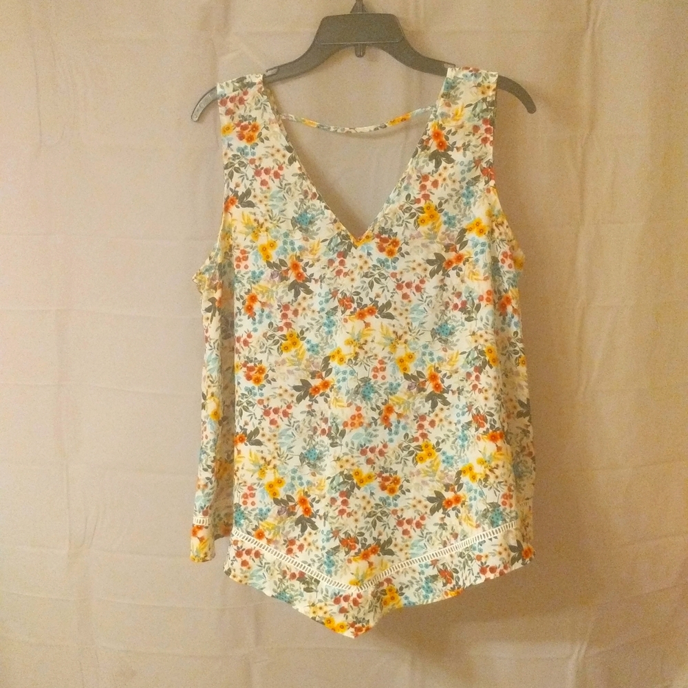 a.n.a Large sleeveless floral blouse v cut bottom with eyelet detail.